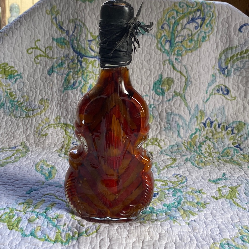 Glass bottle preserved peppers in oil.
